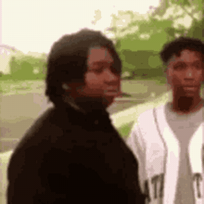 Man In Black Jacket Next To Man In White Shirt GIF