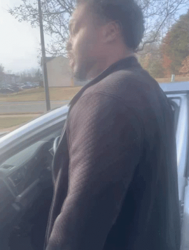 Man In Black Jacket Next To Silver Car GIF