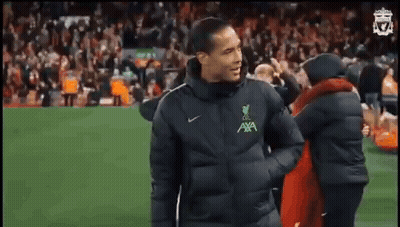 Man In Black Jacket On Soccer Field With Crowd GIF