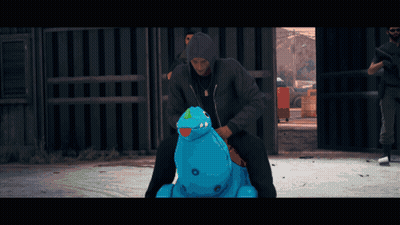 Man In Black Jacket Riding Blue Inflatable Hippopotamus GIF