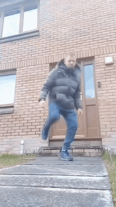 Man In Black Jacket Running Down Stairs GIF