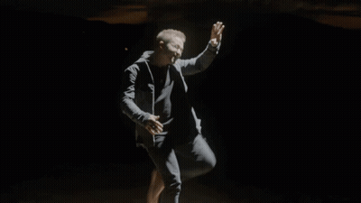 Man In Black Jacket Running Through Smokey Area GIF