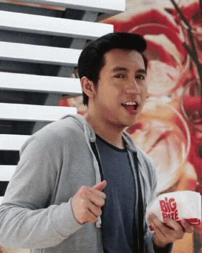 Man In Black Jacket Shopping With Basket Of Snacks GIF