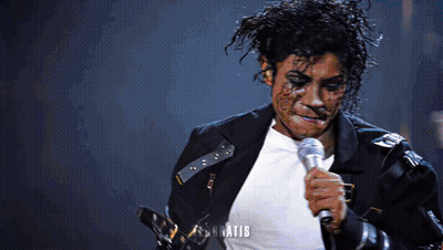 Man In Black Jacket Singing Into Microphone What GIF