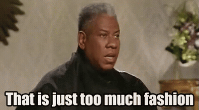 Man In Black Jacket Sitting In Front Of Vase Of Flowers GIF