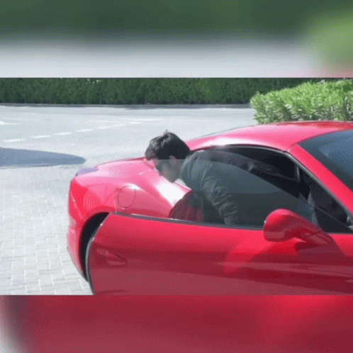 Man In Black Jacket Sitting In Red Car GIF