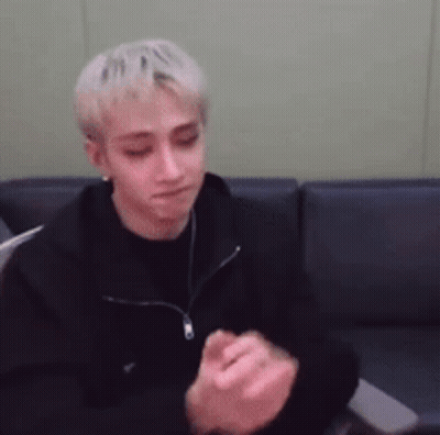 Man In Black Jacket Sitting On Couch With Hands Folded GIF