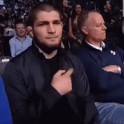 Man In Black Jacket Sitting With Man In Blue Jacket GIF