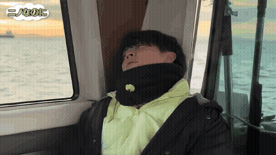 Man In Black Jacket Sleeping On Boat In Ocean GIF