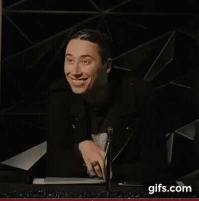 Man In Black Jacket Smiling At Microphone GIF