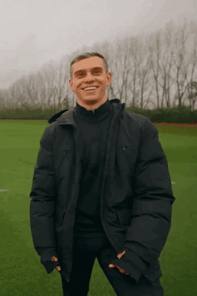 Man In Black Jacket Smiling In Field GIF