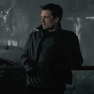 Man In Black Jacket Standing In Dark Room With Eyes Closed GIF