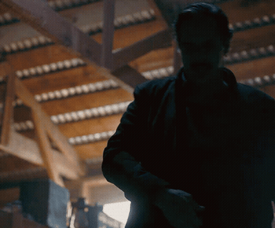 Man In Black Jacket Standing In Dark Room GIF