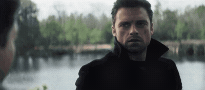 Man in Black Jacket Standing in Front of Lake