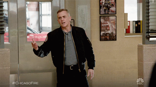 Man In Black Jacket Standing In Hallway With #Chicagofire GIF