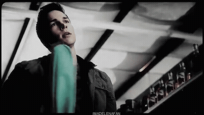 Man In Black Jacket Standing Near Glass Shelf GIF