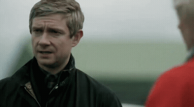 Man In Black Jacket Standing Next To Man In Red Jacket GIF