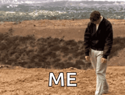 Man In Black Jacket Walking In Dirt Saying Me GIF