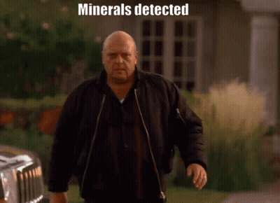 Man In Black Jacket Walking In Front Of Car Saying Minerals Detected GIF