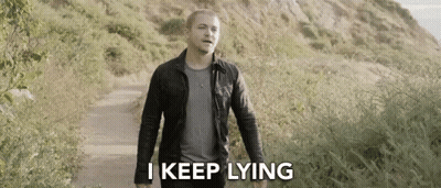 Man In Black Jacket Walking With I Keep Lying GIF