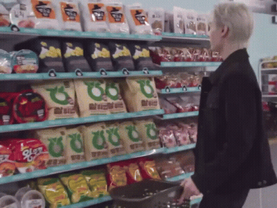 Man In Black Jacket With Basket Of Snacks GIF