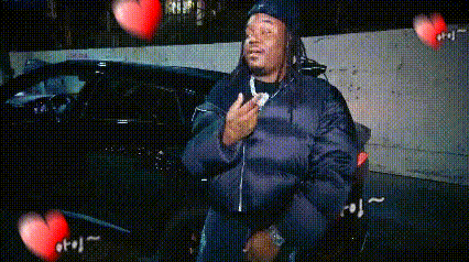 Man In Black Jacket With Flying Hearts GIF