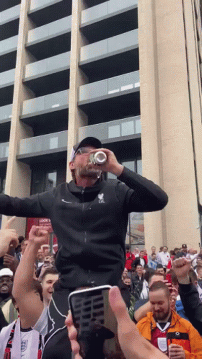 Man In Black Jacket With Letter L Drinking From Bottle GIF