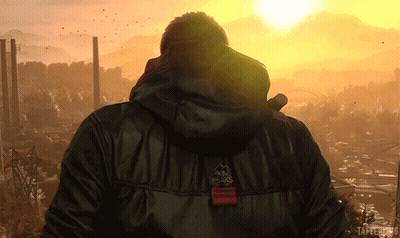 Man In Black Jacket With Peaks At Sunset GIF
