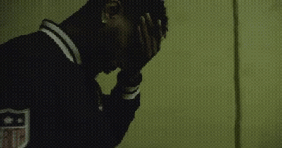 Man In Black Jacket With Shield Covering Face GIF