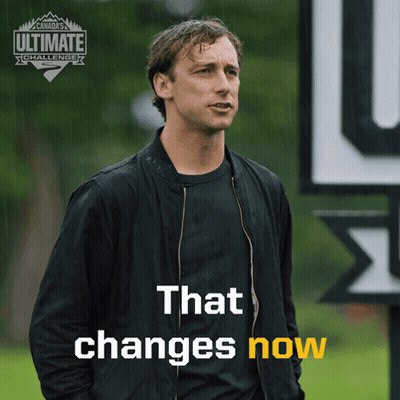 Man In Black Jacket With Sign That Changes Now GIF