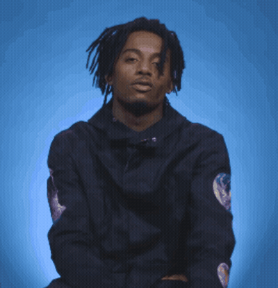 Man In Black Jacket With Sleeve Patch Pointing GIF