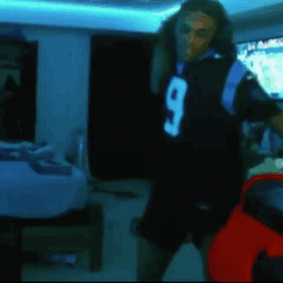 Man In Black Jersey Number 9 Dancing In Dark Room GIF