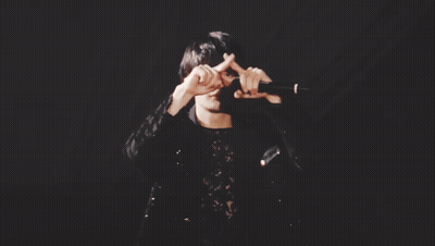 Man In Black Lace Top Holding Microphone GIF