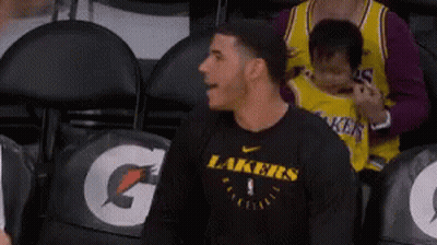 Man In Black Lakers Shirt Sitting In Stadium GIF