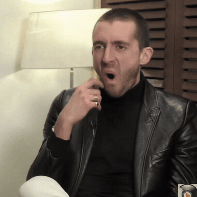 Man In Black Leather Jacket And Turtleneck Making Funny Face GIF
