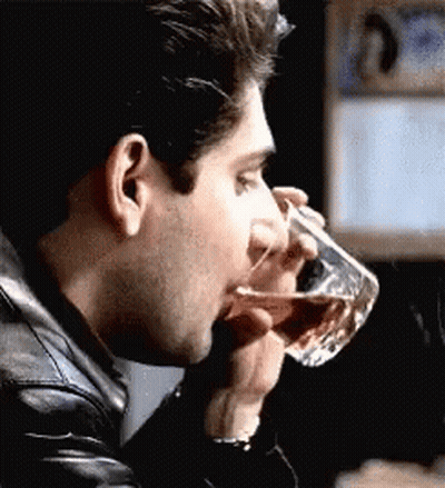 Man in Black Leather Jacket Drinking From Glass