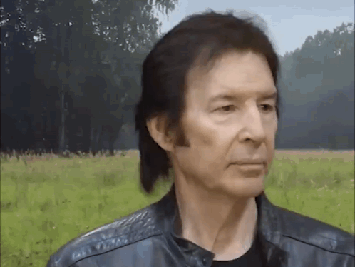 Man In Black Leather Jacket In Field GIF