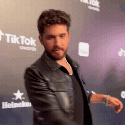 Man In Black Leather Jacket On Heineken Red Carpet GIF