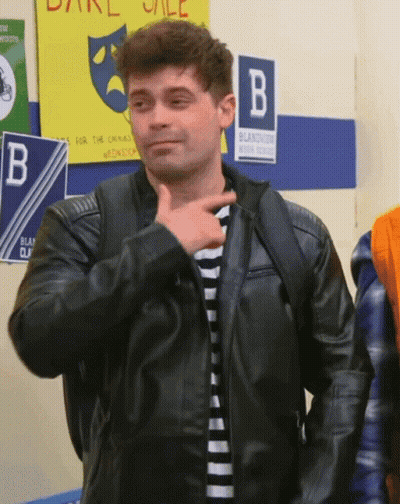Man In Black Leather Jacket Standing In Front Of B Sign GIF