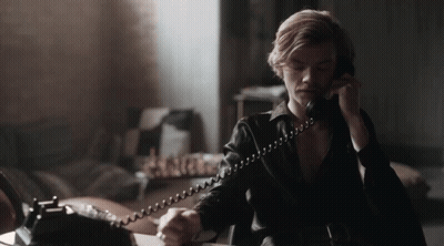 Man In Black Leather Jacket Talking On Phone GIF