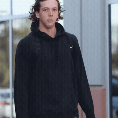 Man In Black Nike Hoodie Standing By Window GIF