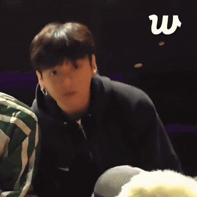 Man In Black Nike Hoodie Stands In Front Of Another Man GIF