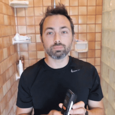 Man In Black Nike Shirt Holding Bottle GIF