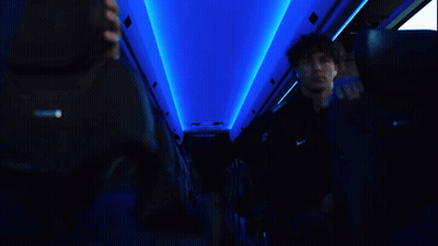 Man In Black Nike Shirt Looking At Phone GIF