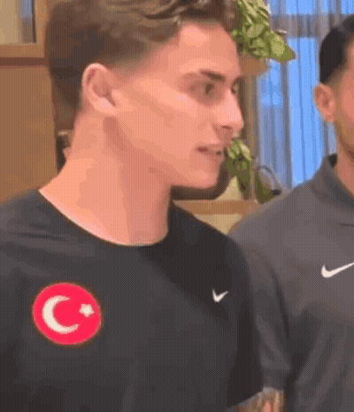Man In Black Nike T-Shirt With Red Star And Crescent Moon GIF