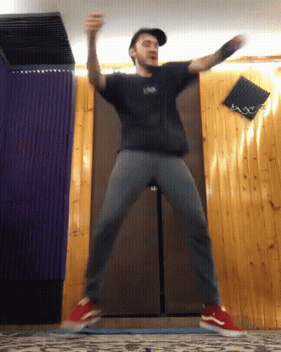 Man In Black Oasis Shirt Jumping GIF