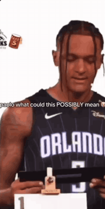 Man In Black Orlando Jersey Holding Paper GIF