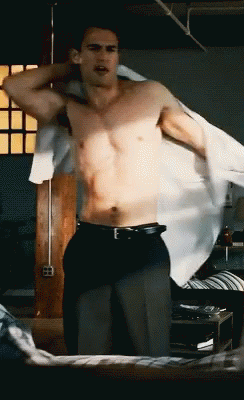 Man in Black Pants and White Shirt Standing on Bed