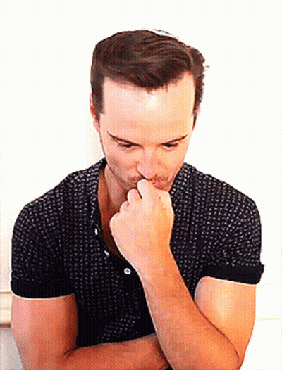 Man In Black Polka Dot Shirt Holding Hand To Chin GIF