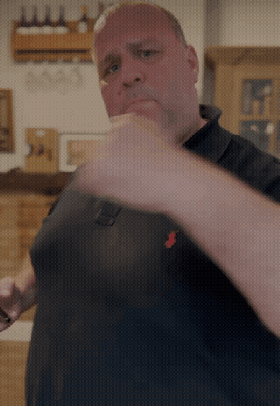 Man In Black Polo Shirt With Red Pony GIF